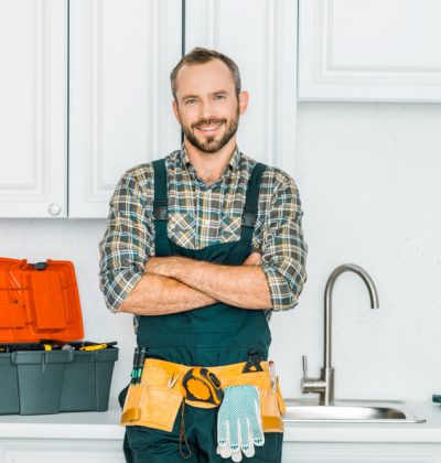 Smiling,Handsome,Plumber,Standing,With,Crossed,Arms,And,Looking,At