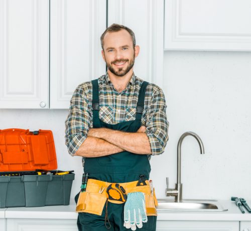 Smiling,Handsome,Plumber,Standing,With,Crossed,Arms,And,Looking,At