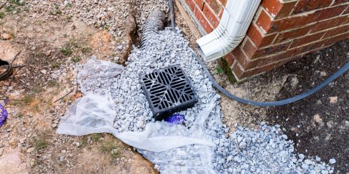 Plastic,Catch,Basin,Installed,Under,A,Downspout,To,Alleviate,Drainage