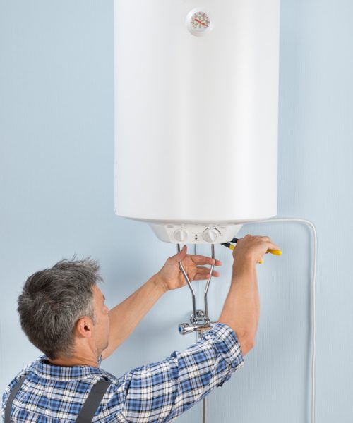 Portrait,Of,Happy,Male,Plumber,Repairing,Electric,Boiler