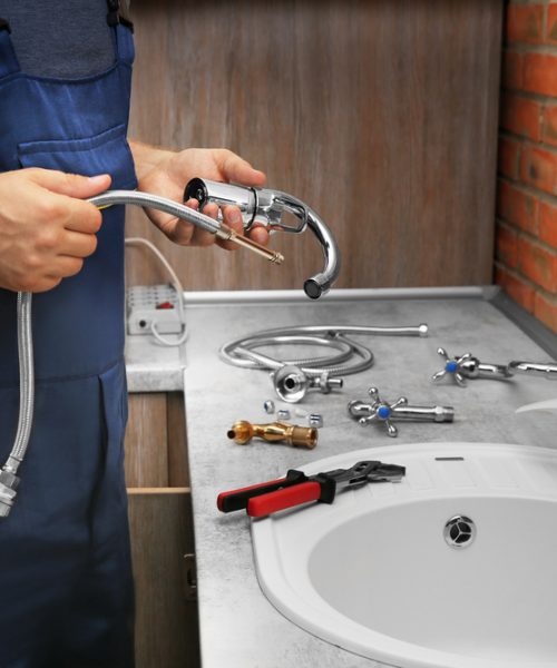 Plumber,Replacing,Faucet,In,Kitchen,,Close,Up,View