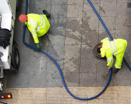 Sewer,Line,Drainage,By,Utilities,Workers,With,Hose,With,Pressurized